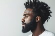 © Volodymyr - Profile of serious young black man with twists hairstyle and beard looking away on white background