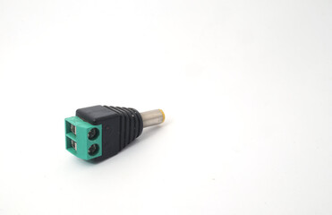 A male DC jack with green screw connection on a white background.