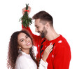 © New Africa - Lovely couple under mistletoe bunch on white background