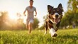 © MAY - A man and his loyal dog playing fetch in a park, the dog sprinting across the grass with boundless energy and enthusiasm.
