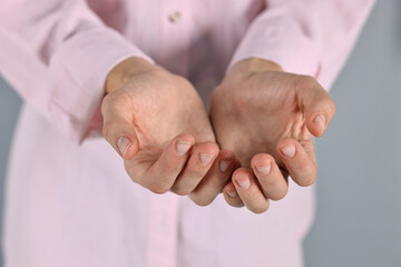Wall Mural - man holding something on grey background, closeup