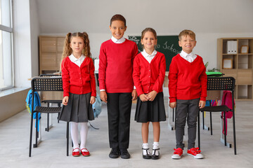 Wall Mural - Portrait of little pupils in classroom