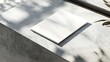 © Handz - Blank Booklet Resting On A Concrete Surface