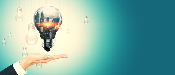 Poster - Hand presenting a glowing light bulb with cityscape inside, surrounded by other bulbs, on a gradient background.