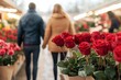 © Downloads - Romantically strolling couple examining vibrant red roses at quaint flower market for Valentine's Day date