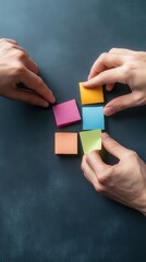 Poster - Creative Hands Arranging Colorful Sticky Notes on a Dark Surface for Brainstorming, Planning, and Organization in a Workspace Setting