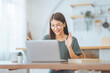 © oatawa - Happy young asian woman using on computer laptop at house. Video conference, Video call, Student lady learning online class.