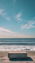 Wall Mural - 23. a calm beach with a stone podium on the shoreline, the ocean waves gently breaking in the backgr