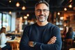 © Margarita - Friendly middle-aged man in modern cafe smiling with confidence
