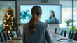 © Tobi - A corporate meeting with a female presenter in front of a room featuring subtle holiday decor