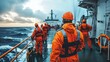 © Tuachan - Crew of Rescue Workers in Orange Safety Gear on Deck of Ship Preparing for Mission at Sea During Dramatic Cloudy Evening with Rolling Waves