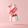 © PhotoArtHub - Colorful gift boxes float against a pink background, evoking excitement and joy for celebrations and special occasions
