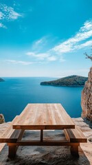 Poster - A wooden picnic table sits on a cliff overlooking a body of water