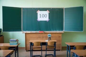 Aufkleber - A classroom with a chalkboard displaying the number 100  suggesting a test or score