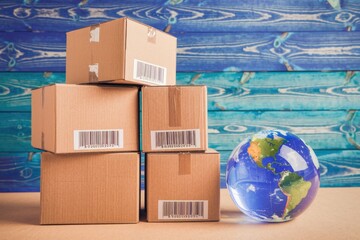 Poster - Stack of cardboard boxes with barcodes  next to a globe  symbolizes global shipping and delivery