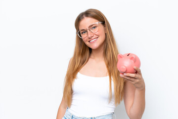 Wall Mural - Young pretty blonde woman holding piggy bank isolated on white background smiling a lot