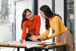 © kenchiro168 - Collaborative women discussing ideas at workspace, showcasing teamwork and creativity. Their expressions reflect enthusiasm and engagement in project