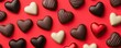 © CassiOpeiaZz - Mockup valentine template concept. Assorted heart-shaped chocolates in various colors on a bright red background, perfect for celebrations and romantic occasions.