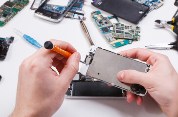 Poster - Repairman disassembling smartphone with screwdriver. Technician fixing broken phone, electronics repair service, repairer pov