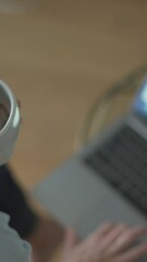 Aufkleber - In todays evolving remote work landscape, a woman enjoys her coffee while working on her laptop, embodying the dynamic lifestyle of a vibrant entrepreneur and motivated freelancer