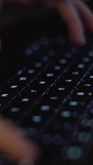 Poster - A person focused on typing away at a laptop keyboard set in a dimly lit environment, where the glow of the screen illuminates their concentration and creates an atmosphere ideal for productivity