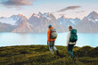 © EVERST - People hiking in Norway couple man and woman traveling with backpack, active vacations healthy lifestyle outdoor in mountains - family climbing Lyngen Alps, adventure freedom endurance concept