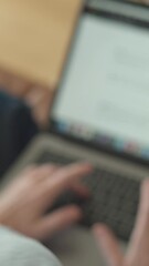 Aufkleber - A focused woman is intently typing on her laptop while comfortably dressed in casual attire from the comfort of her own home, showcasing her dedication and concentration on her tasks