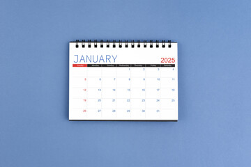 Wall Mural - January 2025 Monthly desk calendar for 2025 year on blue background. Flat lay.