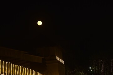 Wall Mural - full moon floating on sky behind wall of temple wall emerald buddha or wat phra kaew travel location