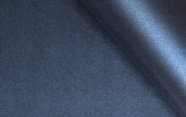 Fototapete - Dark blue rolled paper background with a smooth, glossy texture and luminous shimmer. Elegant and minimalist design featuring sleek tones and premium material. Ideal for modern
