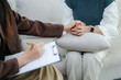 © Jirapaporn - Psychology, depression. smile asian young woman, female patient mental explained symptom with psychologist, psychiatrist while doctor woman taking notes at clinic. Encouraging, therapy.