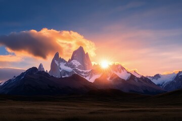 Wall Mural - Breath taking sunset over mountain ranges in a vast golden grassland landscape