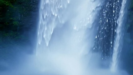 Wall Mural - Waterfall Majesty: Close-up of cascading water, mist, and the powerful rush of a waterfall.  Nature's serene beauty captured in breathtaking detail. 