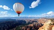 © Lens Legacy - A lone hot air balloon embarks on a voyage above sprawling canyons, cradled by a clear blue sky and scattered white clouds, emphasizing solitude and scale.