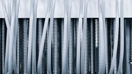 Poster - Dairy machine cooling radiator with a row of stainless steel metal pipes with silver trim. The pipes are connected to each other and appear to be part of a larger system