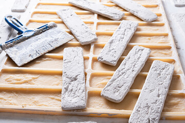 Wall Mural - Closeup pile of white paint bricks and trowel.