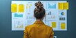 © Watcharaphon - Rank and coordinator concept. Businesswoman analyzing data on a wall display.