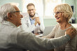 © Goran - Happy mature couple talking during a medical appointment