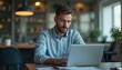 © Anna - man is intently typing on his laptop in a contemporary workspace filled with greenery and soft, warm lighting, emphasizing a productive atmosphere during working hours