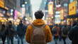 © ChrisKuz - Back view of a man wearing a yellow jacket and backpack in a bustling city street