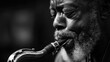 © Abdullah - Close-up of a man playing the saxophone with emotional expression in black and white