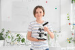 © Pixel-Shot - Teenage boy with microscope in Biology class