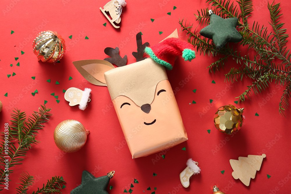 Beautiful Christmas composition with gift box and decorations on red background