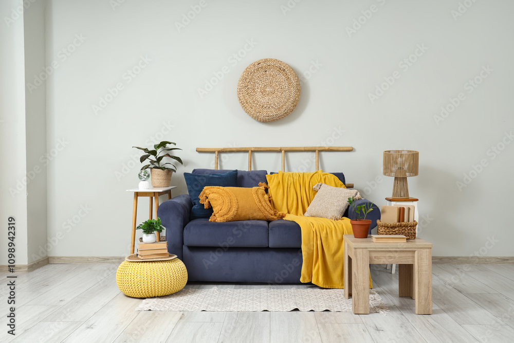 Interior of living room with cozy sofa, coffee table and pouf