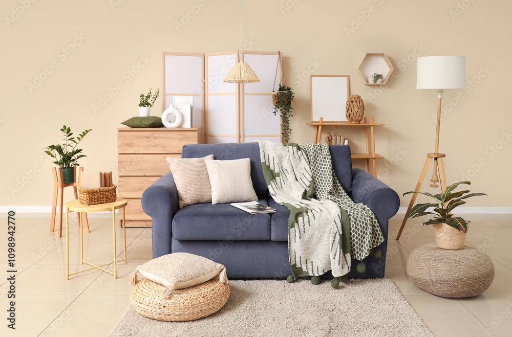 Cozy sofa and poufs in interior of living room
