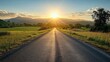 © Mariya - Rural Road at Sunrise with Distant Mountains and Lush Green Fields