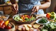 © thesweetsheep - Fresh ingredients being mixed in a bowl, showcasing a vibrant salad preparation process.
