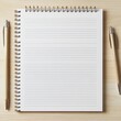 © Ishika - blank notebook with pens on a wooden desk for writing and note-taking