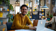 © mahamad - Modern office: Stylish Hispanic businessman working on a laptop, performing data analysis, and smiling. Digital entrepreneur working on an e-commerce project.