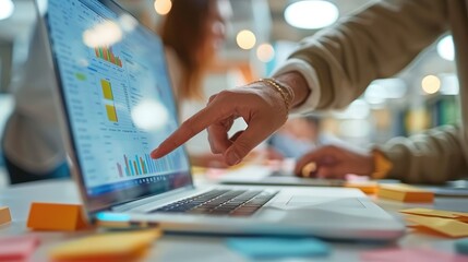 Aufkleber - Group of people working in office. Hand pointing to laptop screen.